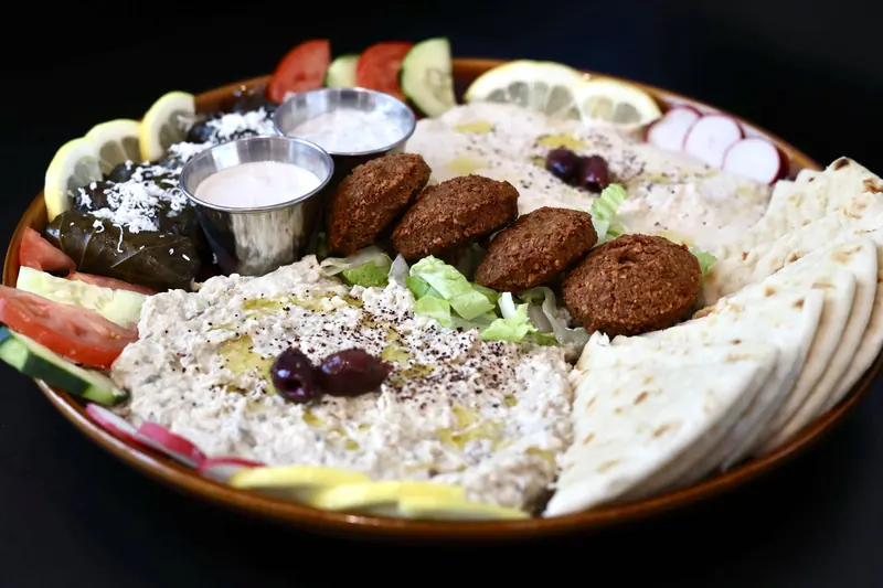 Leymoon Mezza platter with hummus, baba ghanoush, falafel, stuffed grape leaves, fresh vegetables and pita at Leymoon Kitchen